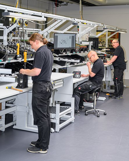 Men doing assembly work in Treston workstations
