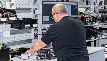 Men doing assembly work in Treston workstations